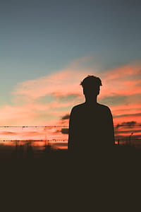 silhouette photo of man during goldentime thumbnail