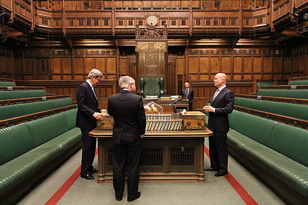 three men standing near table inside conference room thumbnail