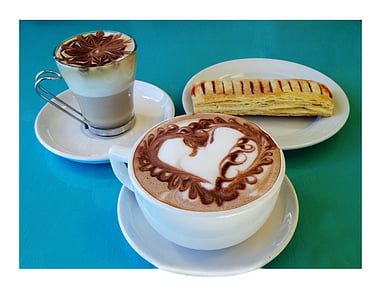 white mug filled with cappuccino and baked bread on white saucer thumbnail
