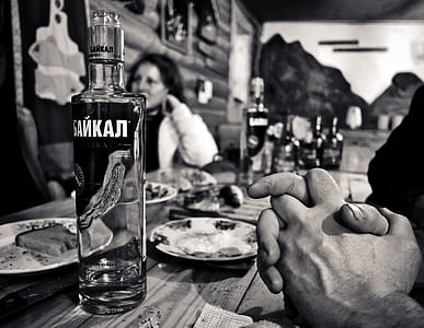 Grayscale Photography of Bottle Beside Saucer thumbnail