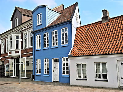 blue and white painted house under blue sky thumbnail