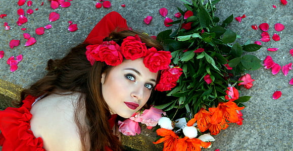 woman lying on flowers and concrete surface thumbnail