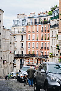 man walking on street near buildings thumbnail
