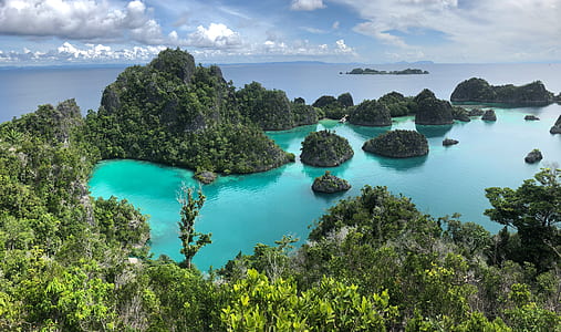bird's eye photography of islands surrounded by water thumbnail