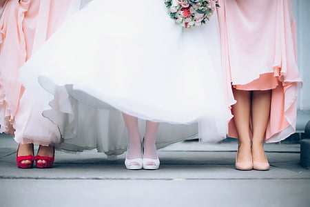 two woman wearing pink dress with woman wearing white dress thumbnail