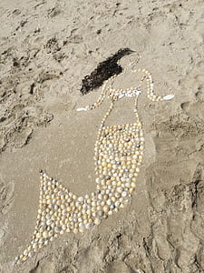 Beige Sea Clams Mermaid Figure on Seashore thumbnail