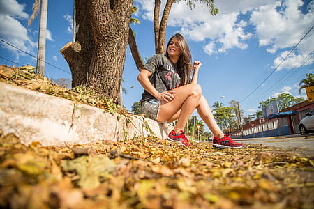 Woman Sitting on Concrete Road thumbnail