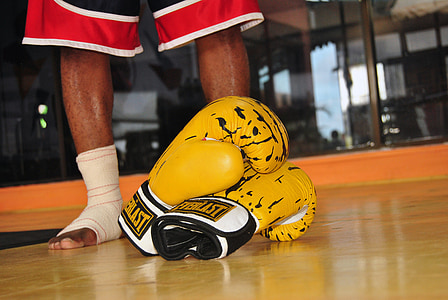 pair of yellow Everlast leather boxing gloves near man standing thumbnail