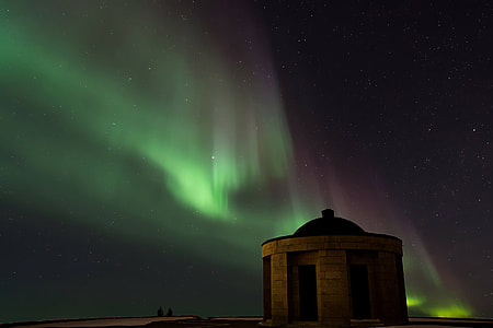 brown and black dome building and Aurora Lights at nighttime thumbnail