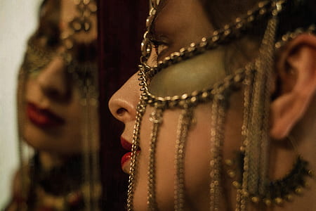 photo of woman wearing gold-colored accessory thumbnail