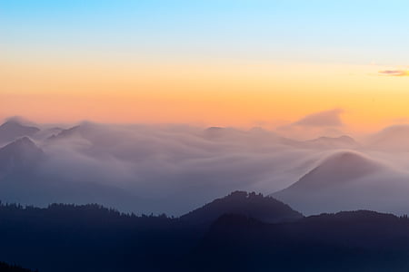 silhouette of mountains under blue and orange sky during sunset thumbnail