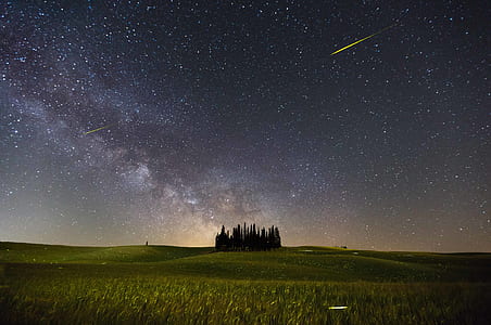 shooting star over green field photo thumbnail