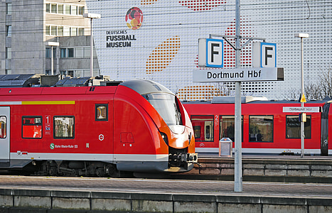 selective focus photography of red train near Dortmund Hbf signage thumbnail
