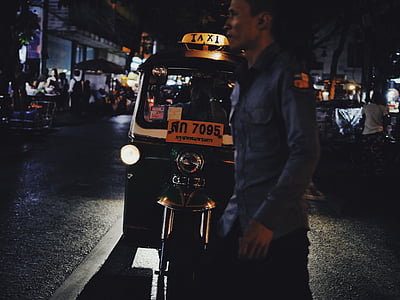 man walking on street in front of auto-rickshaw thumbnail