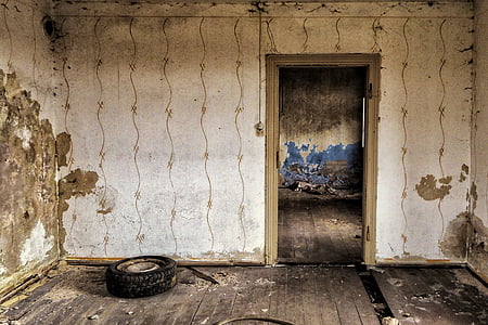 vehicle tire beside brown wooden door thumbnail