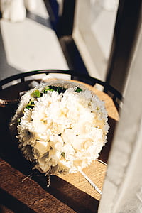 white floral bouquet on brown table thumbnail