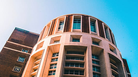 beige high-rise building under blue sky thumbnail
