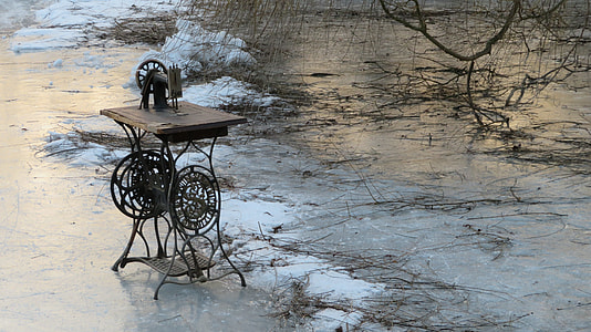 black sewing machine beside body of water thumbnail