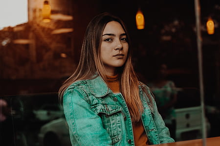woman looking at camera while sitting thumbnail