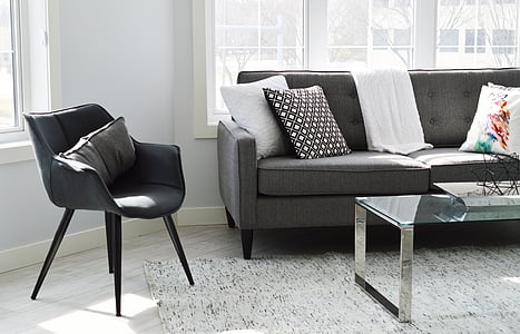 gray pillow on black armchair thumbnail