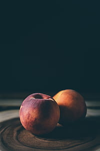 two red apples on brown surface thumbnail