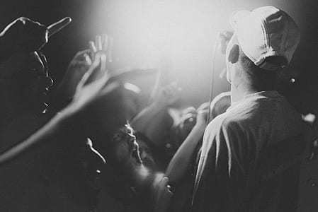 grayscale photo of people gathered while singing thumbnail