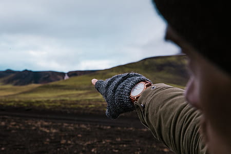 Watch And Gloves On Hand Pointing Photo thumbnail