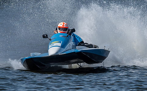 person riding on personal watercraft on body of water thumbnail