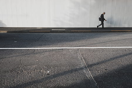 person walking at concrete road thumbnail