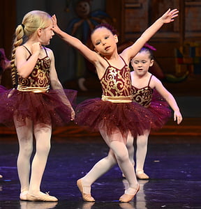 three ballerinas wearing maroon and gold dresses thumbnail
