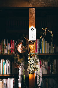 woman hiding from behind on brown wooden panel thumbnail