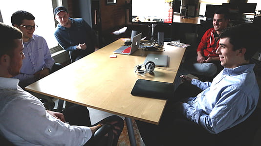 group of men sitting in front of table thumbnail