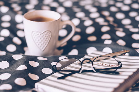 Close-up Photography of Eyeglasses on Top of the Notebook thumbnail