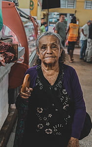 woman holding brown and blue umbrella thumbnail