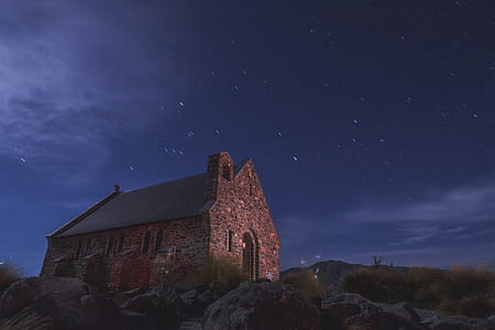time lapse photography of brown house under blue and white sky thumbnail