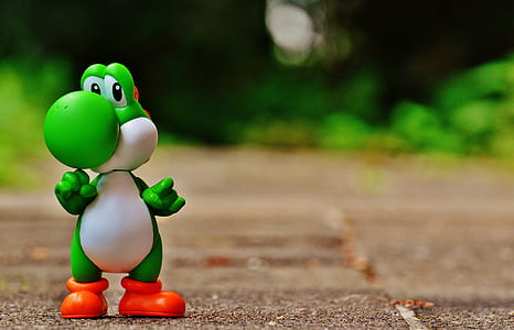 Green and White Dinosaur Toy on Brown Ground in Tilt Shift Photography thumbnail