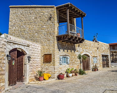 brown brick house under blue sky thumbnail