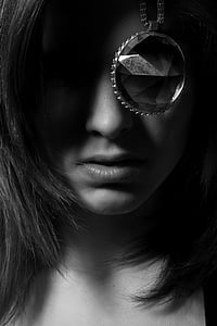 greyscale photo of woman behind pendant necklace thumbnail
