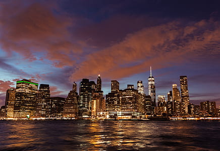 city lights beside body of water during night time thumbnail