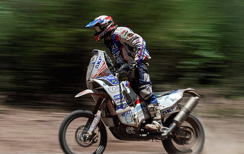 person riding motocross dirt bike during day time thumbnail