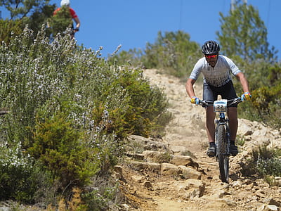 man riding bike on rocky road thumbnail