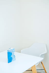 blue covered book on wooden table thumbnail