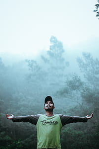 Man Wearing Black and Green Long Sleeve Shirt and Cap thumbnail
