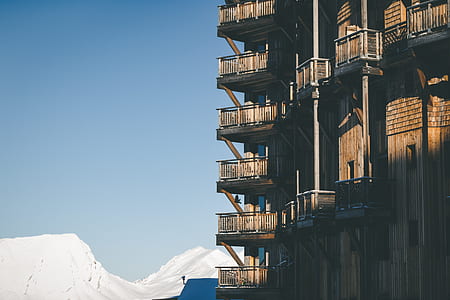 high rise concrete building near white snow mountain at daytime thumbnail