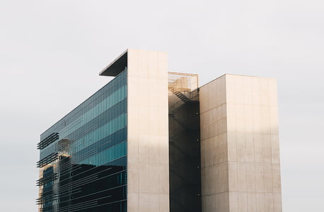 white concrete building under white sky thumbnail