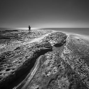 Silhouette of Man Near Body of Water thumbnail