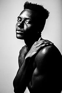 man naked near gray wall thumbnail