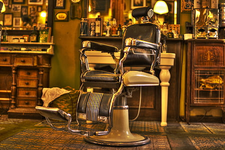 white and black leather barber chair on green floor mat thumbnail