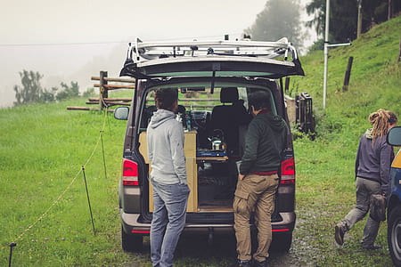 two men standing at the back of black van thumbnail