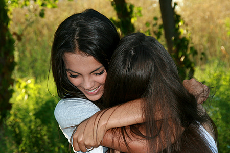 closeup photo of two women hugging each other thumbnail